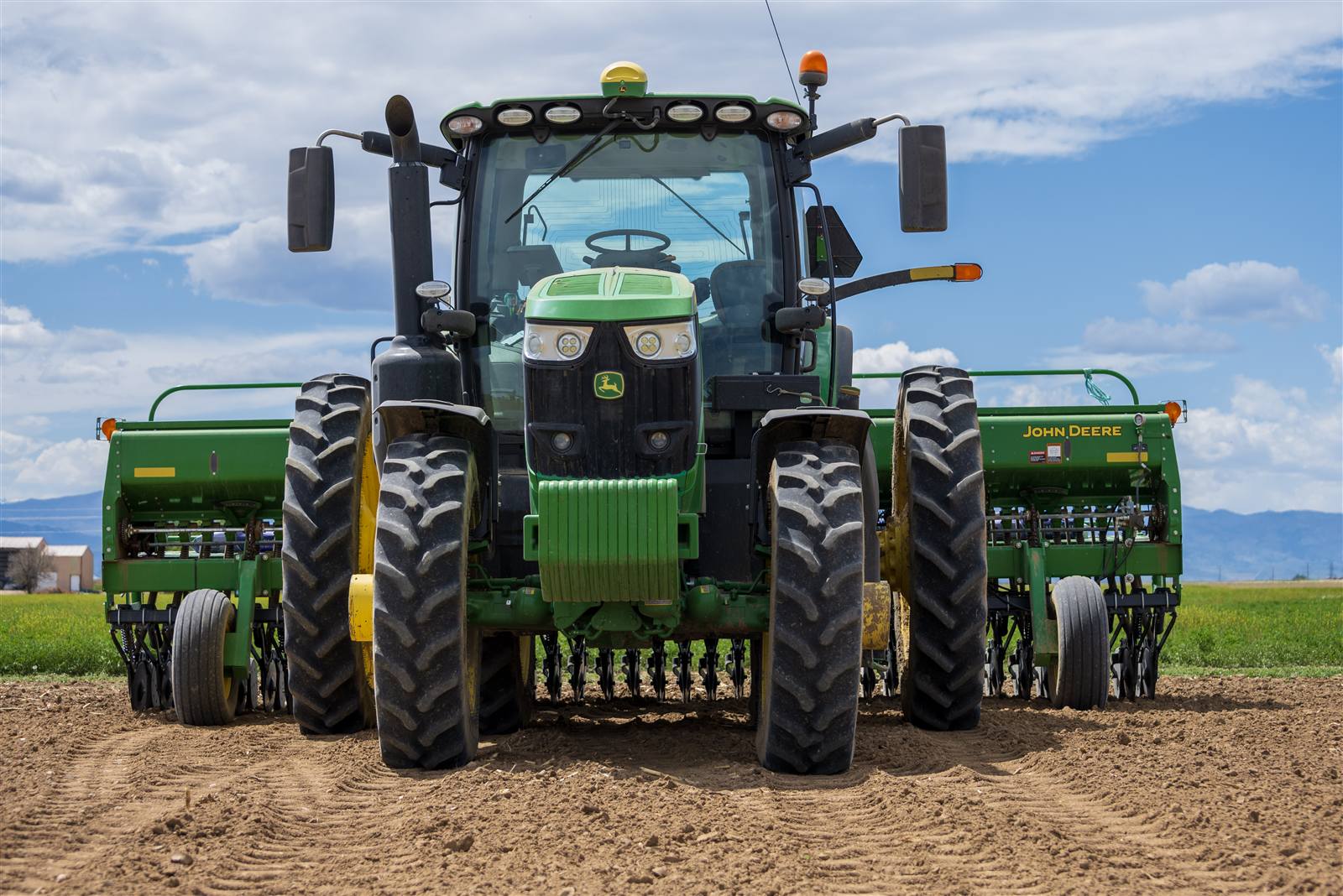 Tractor with seed drills planting a field